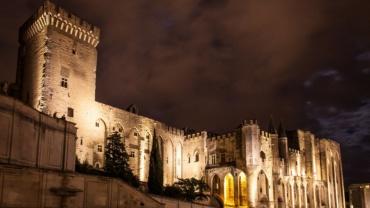 Side view of the Palais des Papes at night