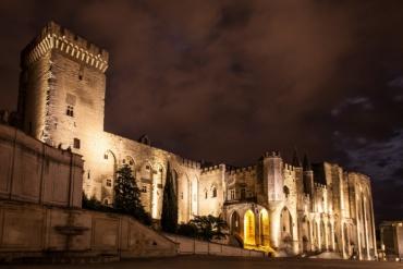 Side view of the Palais des Papes at night